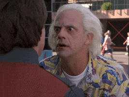 Movie gif. Christopher Lloyd as Doc Brown from Back to the Future gets in Marty's face, eyes wide and wild says, "Why?"