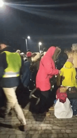 People Fleeing Ukraine Arrive at Polish Border Overnight in Freezing Temperatures