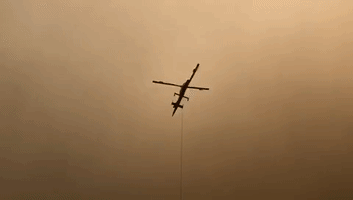 Firefighting Helicopter Scoops Up Water to Battle California's Caldor Fire