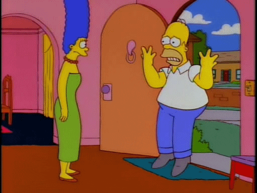 Simpsons gif. Homer is at the door of his home and he jumps on both feet while shaking his hands in the air. He looks very nervous and Marge stands there, staring at him in concern.