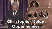 Oscars 2024 GIF. Steven Spielberg effortlessly opens the envelope and announces, "Christopher Nolan. Oppenheimer" for Best Director. We see each of the nominees on the right. 