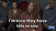 Video gif. Saturday Night Live castmember Mikey Day and guest host Ryan Gosling are dressed as Beavis and Butt-head for a sketch. Day and Gosling are sitting in the front row of a talk show audience. The two of them are staring straight ahead with goofy smiles on their faces. 