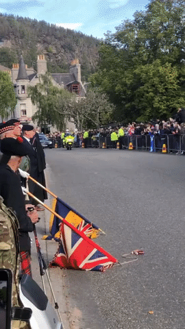 Mourners Watch as Hearse Carrying Queen's Coffin Passes Through Scottish Village
