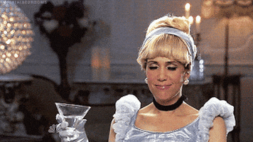Celebrity gif. Kristen Wiig dressed as Cinderella appears to be drunk. She holds a martini glass in one hand and uses the other to wipe something off the corner of her mouth as she says, "Whatever."