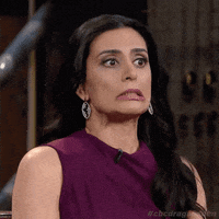 TV gif. Manjit Minhas, a judge from The Dragon's Den, pulls a face and looks horrified at what she's seeing. Her eyes go wide and she grits her teeth while her lips turn down.