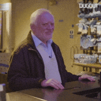 Meme gif. Hide the Pain Harold stands at a counter and turns his face toward us, pops his eyebrows and smiles as if he's trying very hard to seem okay.