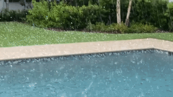 Hail Splashes Into Pool During Thunderstorm in Winter Park, Florida