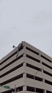 Palestine Flag Unfurled Over Building During Large Protest in Austin