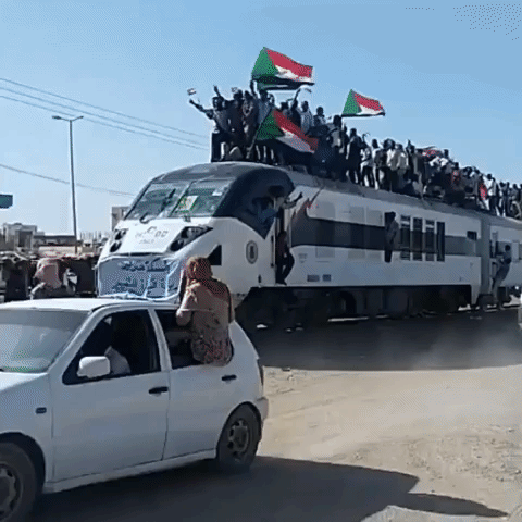 Sudanese Protesters Wave Flags From Roof of Khartoum-Bound Train
