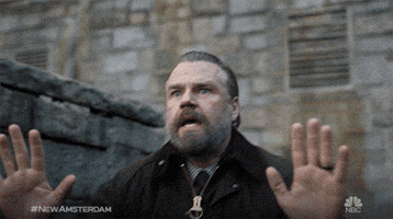 TV gif. Tyler Labine as Dr. Iggy in a dramatic low shot backs away from something slowly with a look of distress and fear on his face.