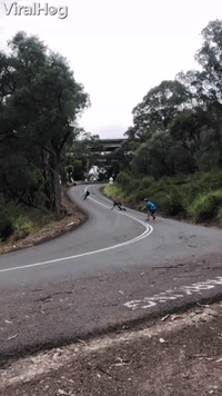 Downhill Skateboarder Takes Out Cameraman