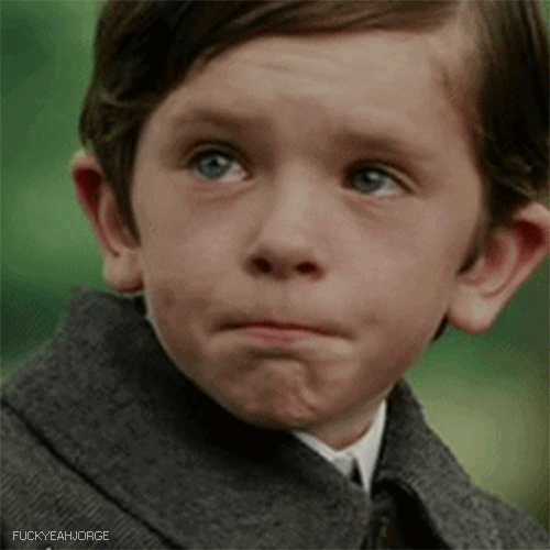 Movie gif. Freddie Highmore as Peter in Finding Neverland looks up at someone with teary eyes, trying to keep his lips tight so he won’t cry, but he can’t help but frown.