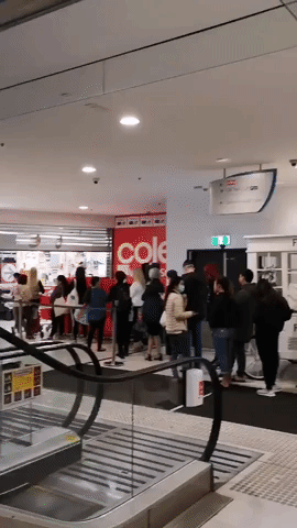 Long Line of Shoppers Wait for Supermarket to Open in Sydney City Centre