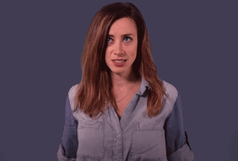 Celebrity gif. Chiara Sottile cringes innocently saying "oops," her hands jumping to her mouth to hide her incongruent smile.