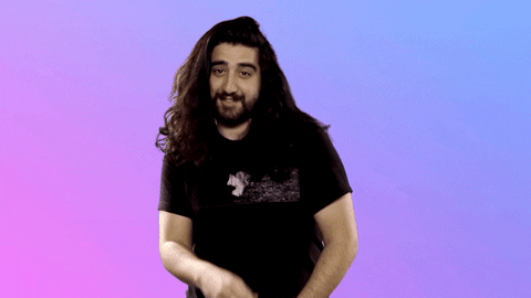 Celebrity gif. Andy Anaya covers his mouth his hand cheekily. Text reads, "Oops," all against a purple to blue gradient background.
