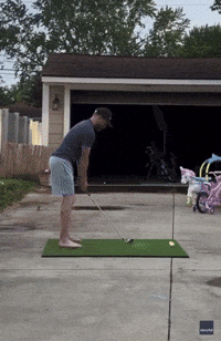 Ow! Golfer Accidentally Ricochets Ball Off Garage Directly Into His Knee