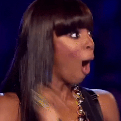 Reality TV gif. Kelly Rowland on the X Factor turns with wide eyes and a flabbergasted look on her face. 