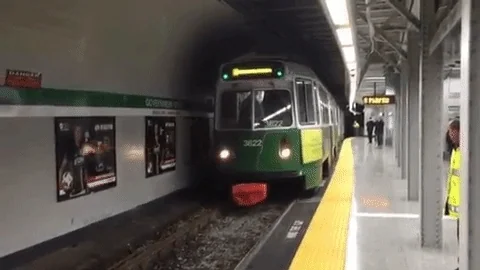 gif of a green light rail vehicle/train arriving at a passenger platform, specifically Government Center station on the MBTA green line in Boston, Massachusetts