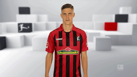 Sports gif. Freiburg Football player puts his hand over his eyes and pretends to search around. He then looks at us and points as if he finally found us.