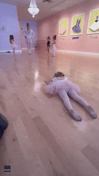 Three-Year-Old Ballerina Slithers Across Floor During Class