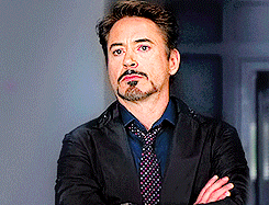 Movie gif. Robert Downey Jr. as Tony Stark in Iron Man has his arms crossed and he rolls his eyes dramatically. 