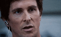 Movie gif. Christian Bale as Michael in The Big Short reacts with a wide, jovial smile.