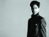 Celebrity gif. The artist formerly known as Prince walks across the frame shaking their head in disgust.