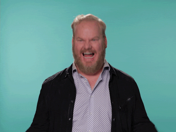 Celebrity gif. Jim Gaffigan shakes his fists and bobs his head wildly as his mouth gapes open in a smile.