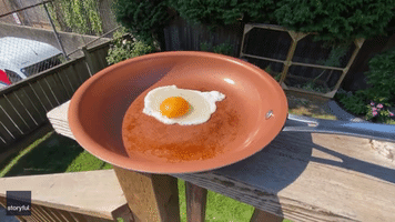 Man Fries Egg in Pan Outside Amid Heat Wave