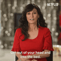 Reality TV gif. Julia Haart on My Unorthodox Life waves her hand in an arc in front of her space and says, "get out of your head and into the bed," which appears as text.