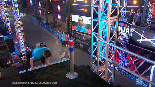 Reality TV gif. A boy on American Ninja Warrior steps onto a stage pumped up as smoke shoots up around him. Text, "Let's go." 