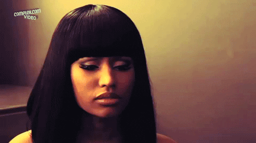 Celebrity gif. Nicki Minaj cocks her head to the side and appears surprised, mouthing, "Oh."