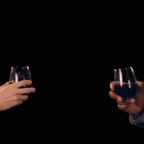 Dvě ruce připíjející si nápoji na pozadí padajících konfet v gifu.