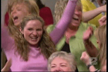 Video gif. An audience of women in a series of shots scream, dance, and cheer, overjoyed, many in disbelief. Some hug each other, others fall to their knees all very excited to be gifted something by Oprah.