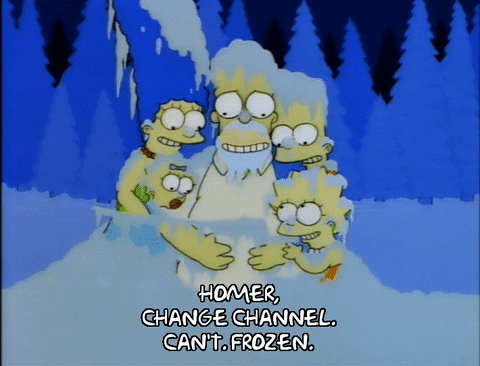 The Simpsons family is sitting on the floor, covered in snow, icicles in their hair and noses. Marge says "homer, change the channel." - Homer responds "Can't. Frozen".