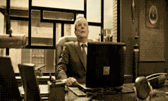 Meme gif. Sepia-toned video of an old man behind an office desk, taking a deep breath before grabbing his laptop, punching it, smashing it against the desk, and turning to toss it out a window.