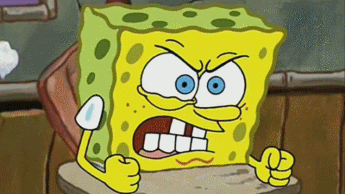 SpongeBob gif. Spongebob sits at his school desk and angrily glares. He grits his teeth and has both of his hands tightened into fists. 