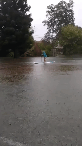 Woman Paddleboards on Flooded Northern California Running Track During Record-Breaking Storm