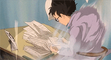 Anime gif. Jiro Horikoshi in The Wind Rises sits at a desk and writes with a pen on paper, as wind violently whips upwards around him, making his clothes thrash wildly, and pages from his desk fly away.