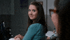 TV gif. Alison Brie as Annie Edison on Community turns around in her seat to look at a girl behind her. She gives a big smile and thumbs up, and then turns back around awkwardly.