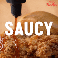 Sponsored gif. Frank’s RedHot sauce is slowly drizzled across crispy fried chicken. Text reads, “Saucy.”