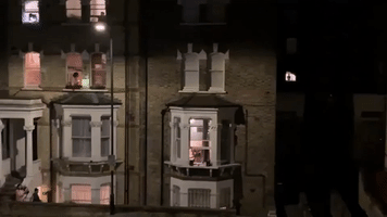 Guitarist Plays 'God Save the Queen' Out Window as Neighbors Clap for Health Care Workers