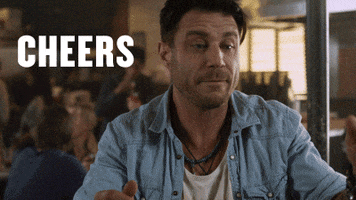 Movie gif. In a clip from Sharknado 3, a man lifts a beer and takes a drink. Text, “cheers.”
