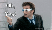 TV gif. David Tennant as Tenth Doctor in Doctor Who points while wearing 3D movie glasses. Text reads, "Oh, yes!"