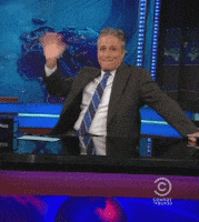 waving jon stewart GIF