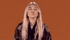 Celebrity gif. Hayley Kiyoko closes her eyes and gives us a bunch of kisses.