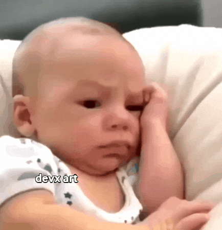 Video gif. A newborn baby is laying in a crib and he has his hand on his forehead and his eyebrows are furrowed in concern.