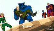 TV gif. A windy scene from the season one finale of the animated TV show "X-Men 97" shows Rogue, Beast, Professor X, Magneto and Nightwalker standing on a sandy cliff looking below them at their surroundings. Beast is cradling Professor X, who is without his wheelchair, and says "Oh no." 