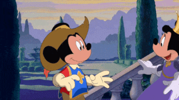 Cartoon gif. Minnie dressed as a princess runs to plant a smooch on Mickey, pulling down the sombrero he is wearing to hide their kiss from us. The clip cuts to Mickey with red lipstick in the shape of a kiss on his mouth, his expression melting with love sickness.