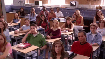Movie gif. Rachel McAdams as Regina George in Mean Girls receives applause from her classmates. 